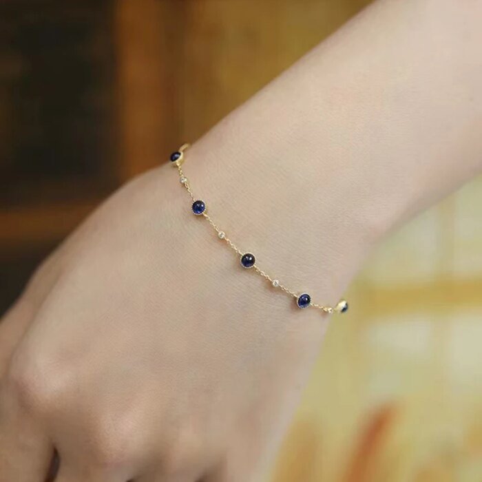 Silverarmband med blå kula och gulddetaljer - Image 3